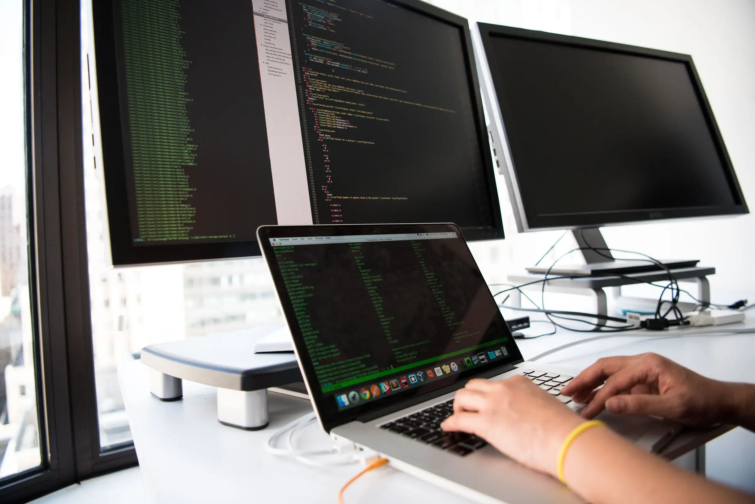 Developer building an app across several monitors